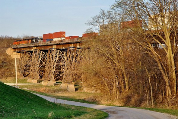 There’s a good bet that many of these containers flying east to Chicago over the Ellis Creek Viaduct in Media, Illinois on the BNSF Railway have products that require labels—but which type, and when must they be applied? Photo copyright 4/2015 by Paul Burgess; all rights reserved.