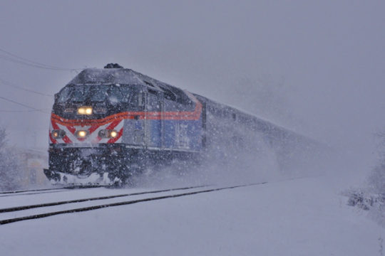 The FRA issued a new Safety Advisory related to operating practices around stations and terminals following rail passenger incidents on the East Coast last year. Here a Chicago Metra commuter train makes heavy going through a snowstorm in Deerfield, Illinois in November of 2015. Image © 11/2015 by Nikki Burgess; all rights reserved.