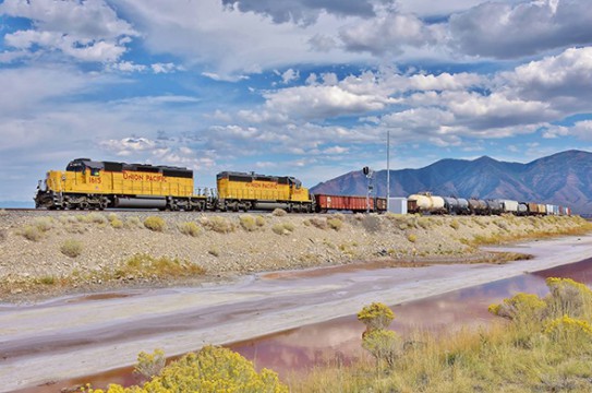 If made law, under House Bill HR 3651 trains carrying passengers and or certain hazardous materials will be able to operate as is as the current PTC deadline is extended from Decmber 31st 2015 to December 31st 2018. Here a Union Pacific freight train operates near the Great Salt Lake in Utah. (image © 9/2015 Nikki Burgess; all rights reserved)