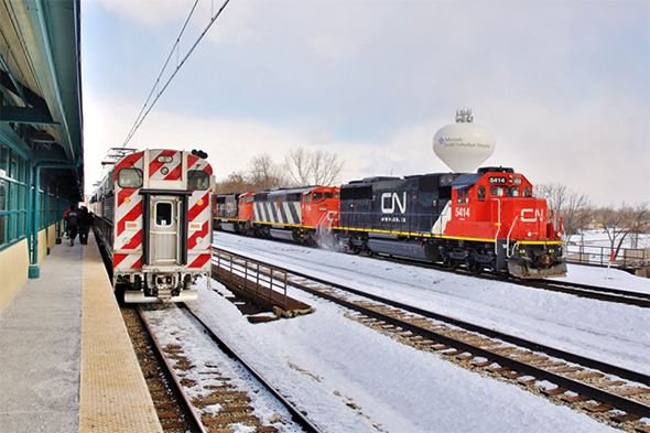 The Surface Transportation Board (STB) is being asked to help solve a control dispute involving a commuter rail agency and a common carrier freight railroad that share track. At issue—hazardous materials. Here, a CN freight train passes a Metra Electric Commuter train (Note: NOT the entities involved in the dispute) in Matteson, Illinois in February, 2015. © 2/2015 by Nikki Burgess; all rights reserved.